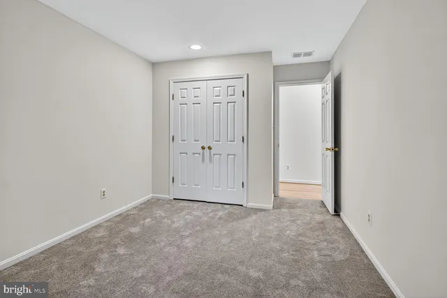 an empty room with closet area