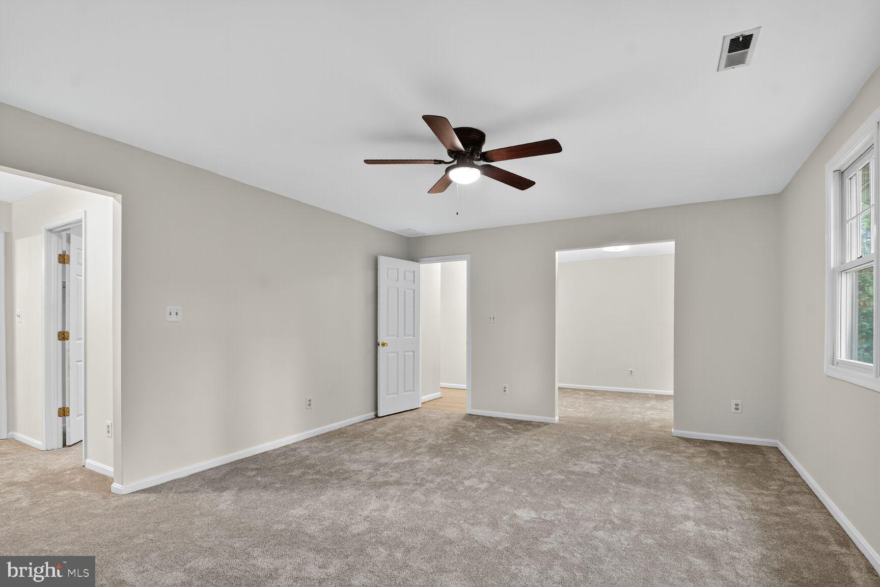 11902 Bernard Drive Silver Spring, MD 20902 - Photo 34 of 47 a view of a livingroom with a ceiling fan & window