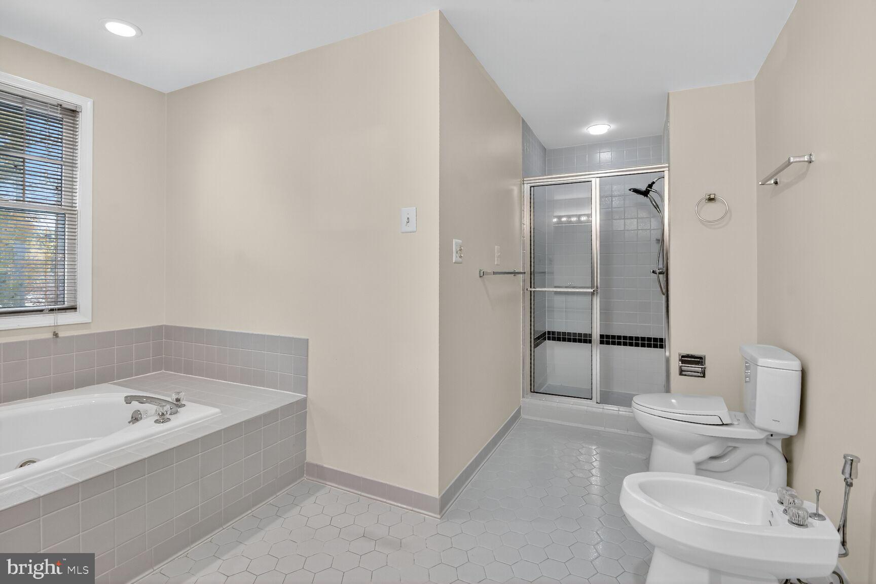 11902 Bernard Drive Silver Spring, MD 20902 - Photo 37 of 47 a bathroom with a tub sink and mirror