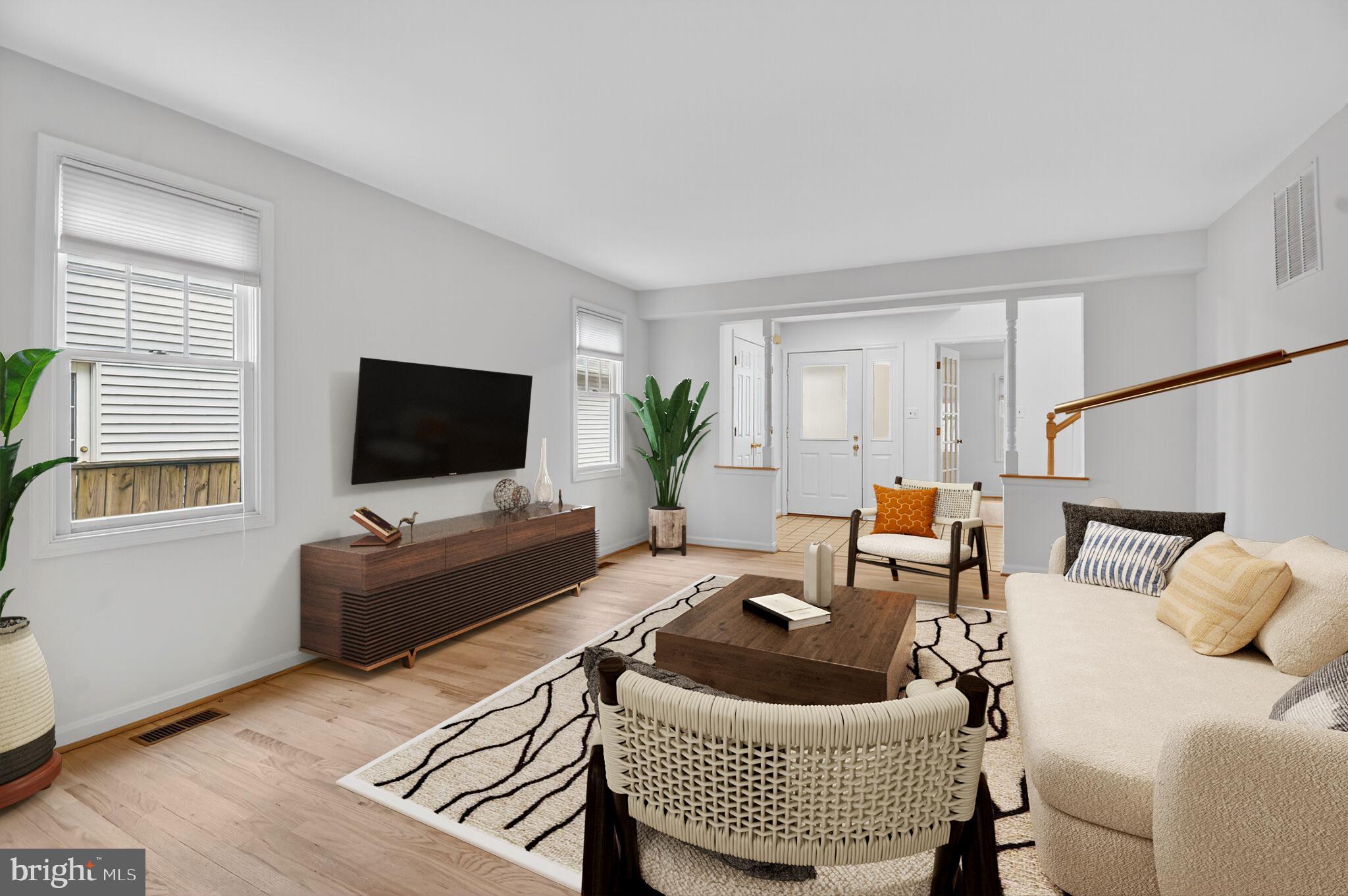 11902 Bernard Drive Silver Spring, MD 20902 - Photo 8 of 47 a living room with furniture and a flat screen tv