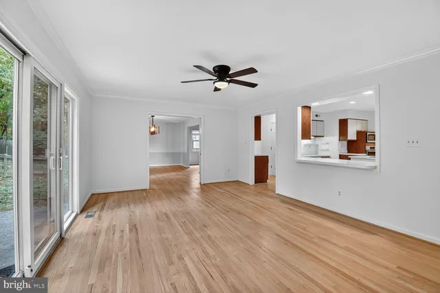 a view of a kitchen with furniture and wooden floor