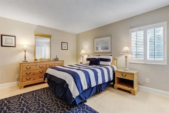 a bathroom with a sink toilet double vanity and shower
