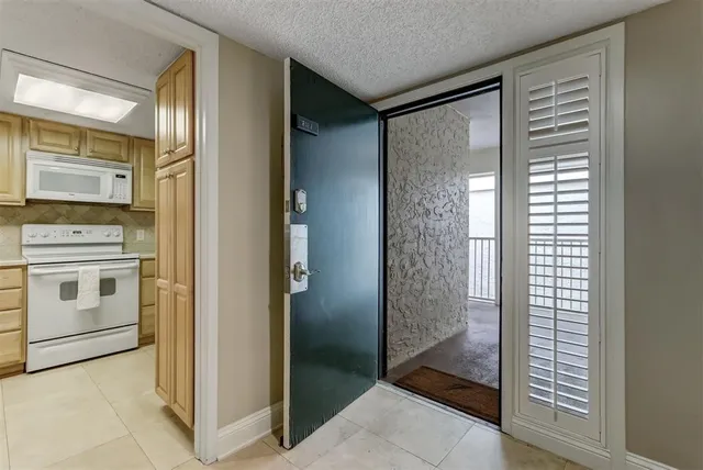 a kitchen with cabinets appliances a sink and a counter top space
