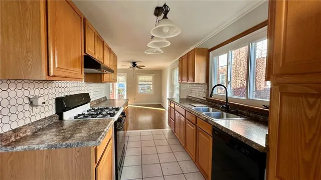 a kitchen with stainless steel appliances granite countertop a sink stove and cabinets