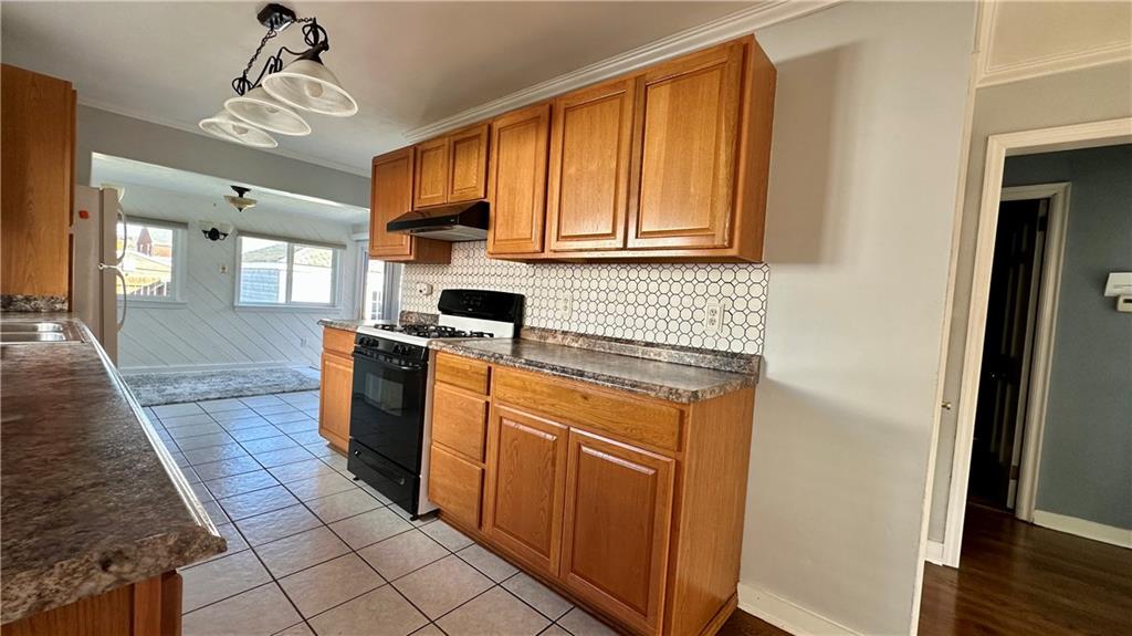 111 South Atlantic Avenue Cheswick, PA 15024 - Photo 14 of 43 a kitchen with stainless steel appliances granite countertop a refrigerator a sink dishwasher and wooden cabinets with wooden floor