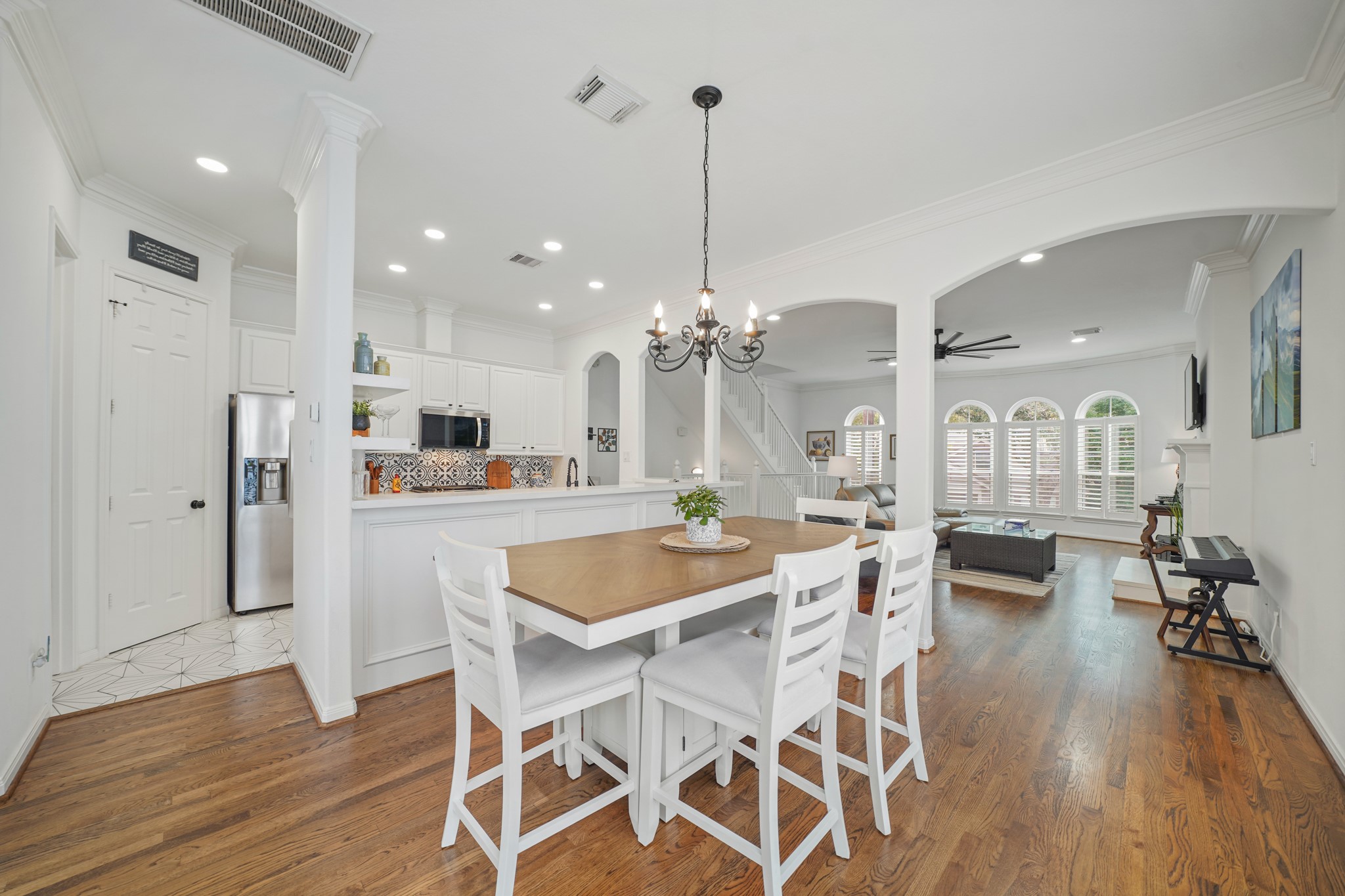 1330 Malone Street Houston, TX 77007 - Photo 12 of 23 Dining area is conveniently located between the kitchen and family room. SO pretty with the updated lights and hardwood floors!