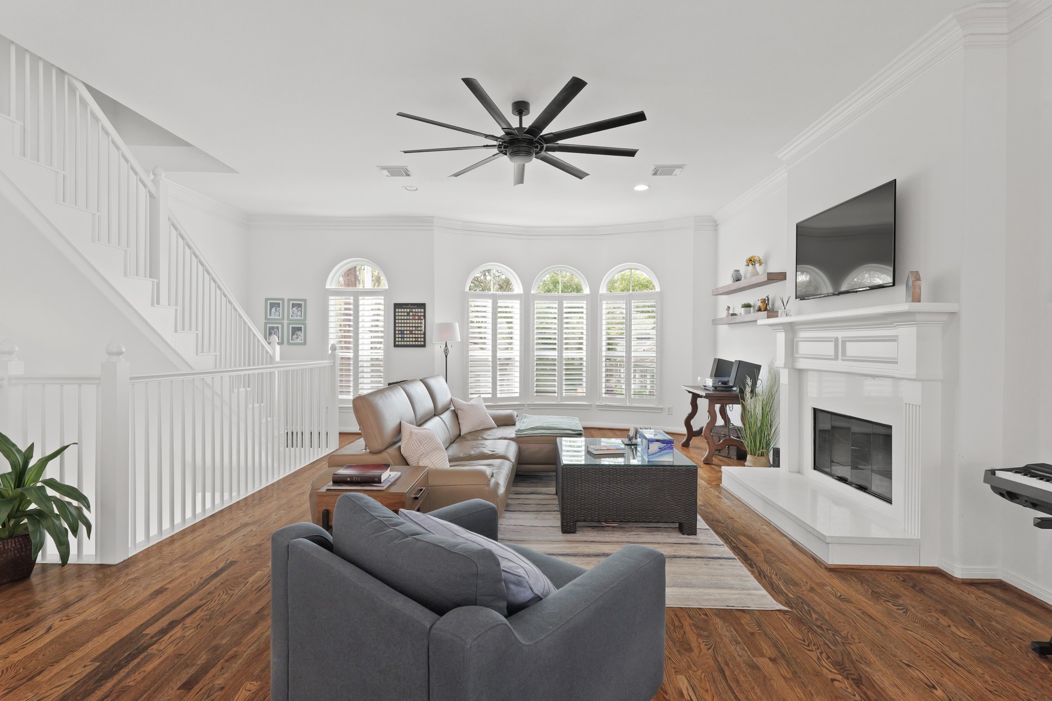 1330 Malone Street Houston, TX 77007 - Photo 13 of 23 New windows frame this family room, and the natural light brings out the best in these hardwood floors!