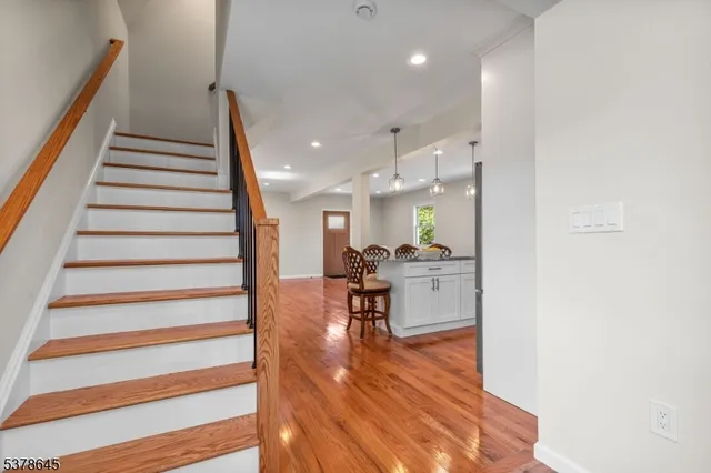 a view of entryway and hall with wooden floor