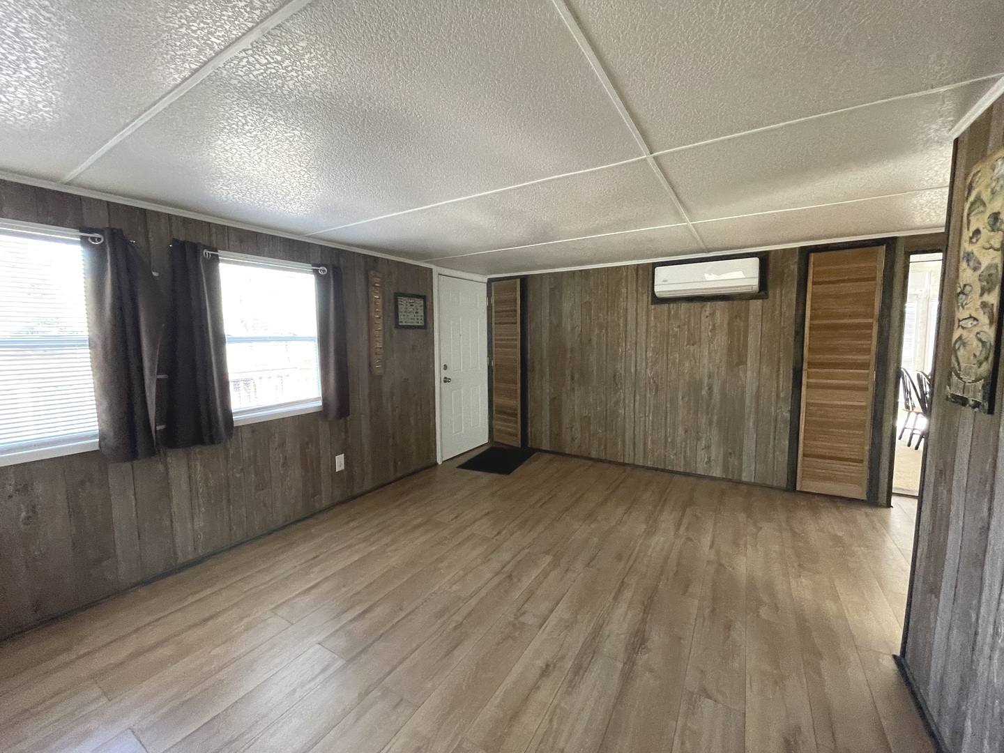 3-71 Woodhaven Lakes Sublette, IL 61367 - Photo 13 of 27 an empty room with wooden floor and windows