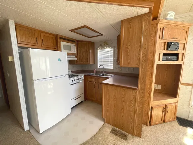 a dining room with furniture a chandelier and window