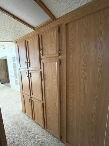 a view of a livingroom with an empty space and a window