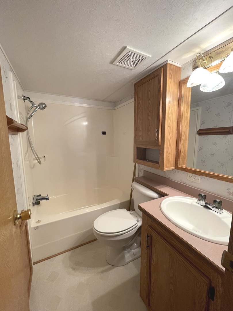 3-71 Woodhaven Lakes Sublette, IL 61367 - Photo 21 of 27 a bathroom with a sink a toilet and shower