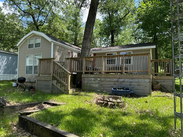 a backyard of a house with yard and barbeque oven