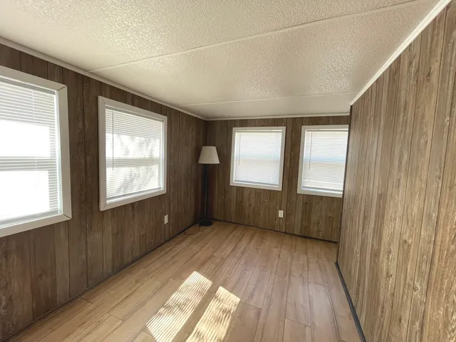 a view of a livingroom with hardwood floor and staircase