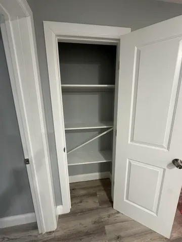 a view of closet with wooden floor