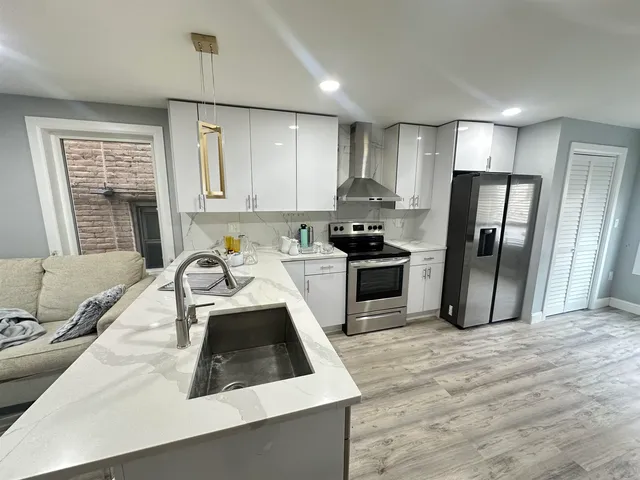 a kitchen with a sink a refrigerator a stove a microwave and cabinets