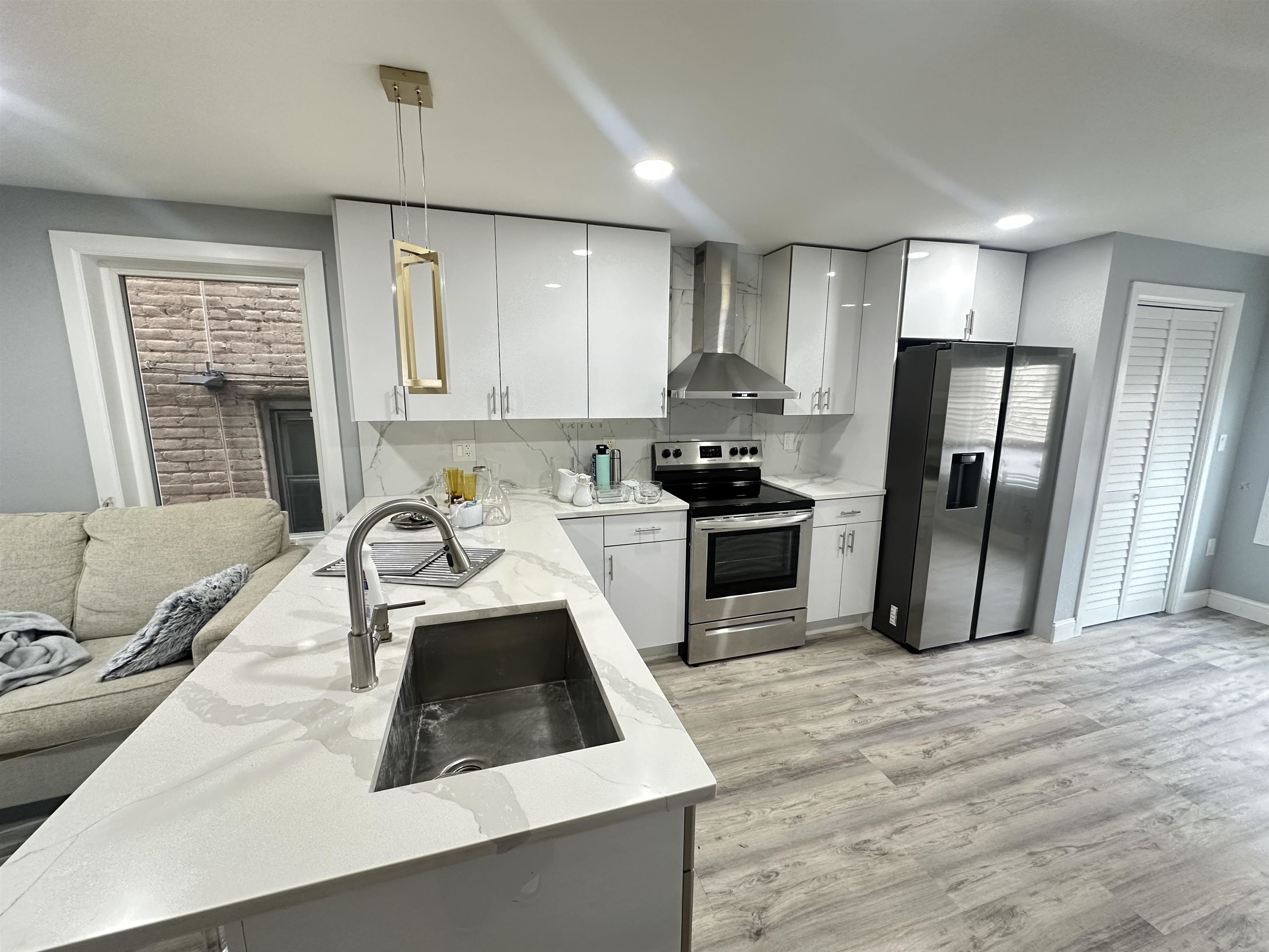 514 43rd Street, Unit 2 Union City, NJ 07087 - Photo 2 of 14 a kitchen with a sink a refrigerator a stove a microwave and cabinets