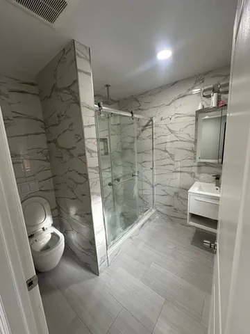 a bathroom with a shower and a toilet