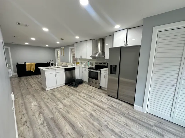a kitchen with refrigerator and microwave