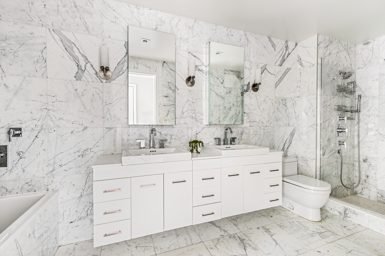 357 Henry Street Brooklyn, NY 11201 - Photo 7 of 9 a spacious bathroom with double sink a toilet a mirror and shower