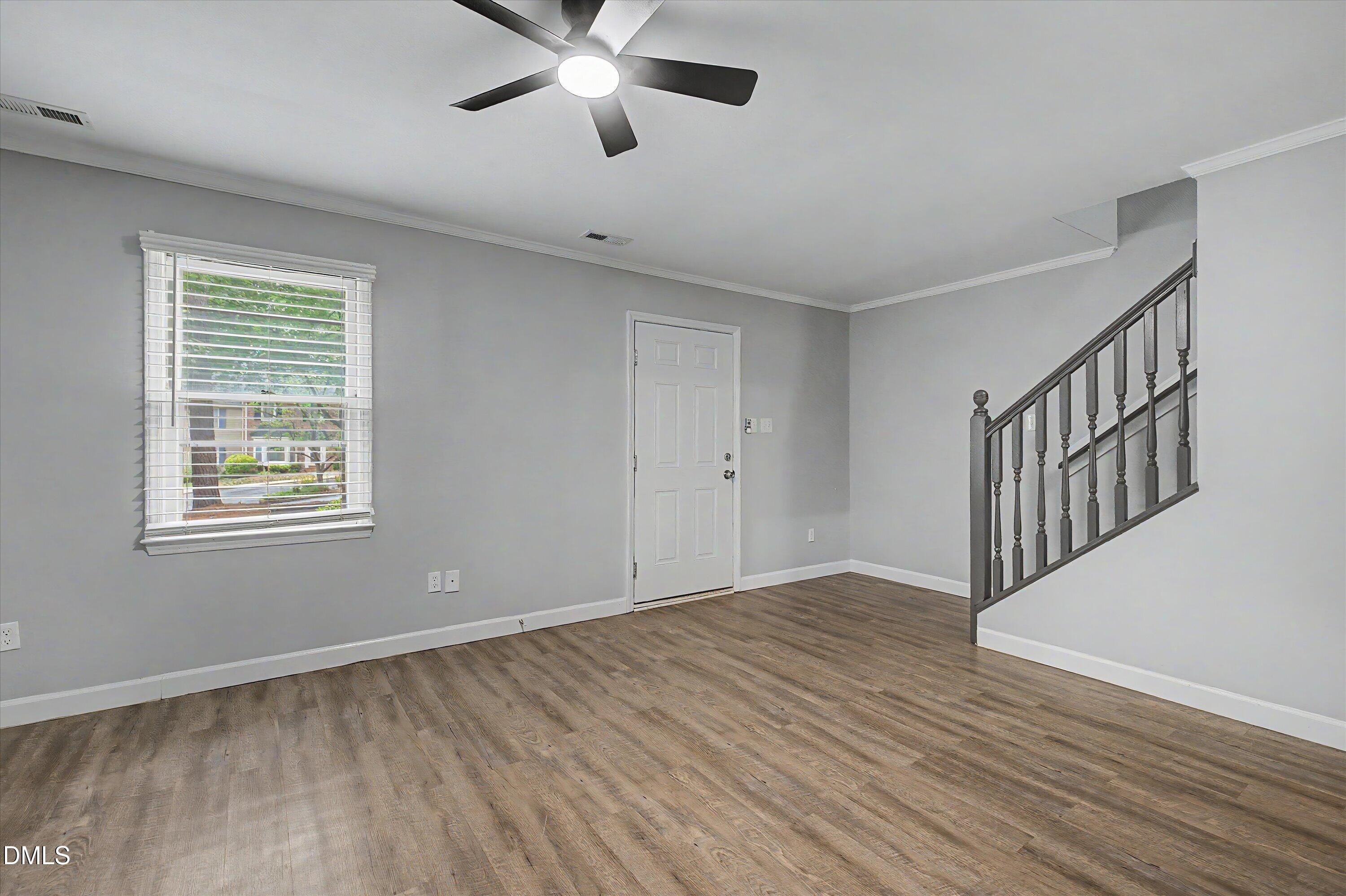 5519 Hamstead Crossing Raleigh, NC 27612 - Photo 6 of 33 wooden floor in an empty room with a window