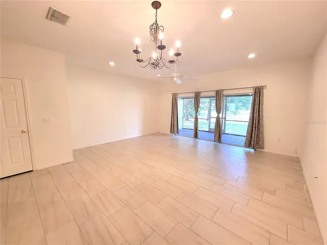 a view of an empty room with glass door