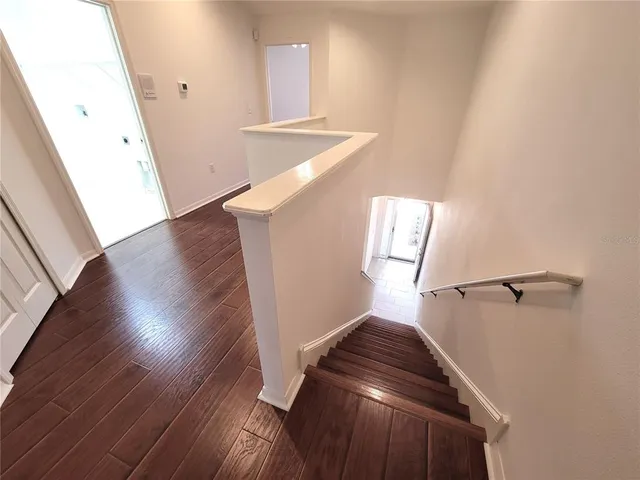 a view of entryway and hall with wooden floor