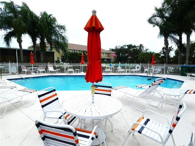an outdoor sitting area with furniture and wooden floor