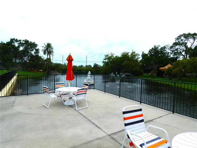 a view of swimming pool with lounge chairs