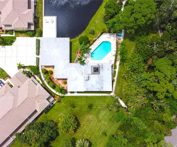 a view of backyard with swimming pool and outdoor seating