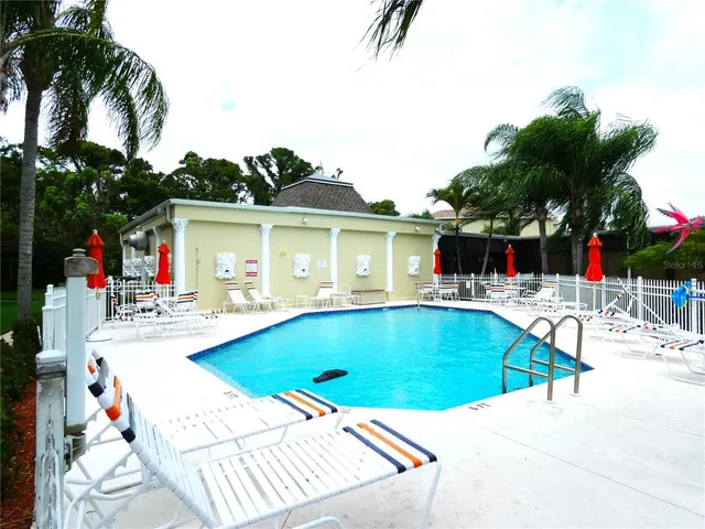 a view of swimming pool with a table and chairs