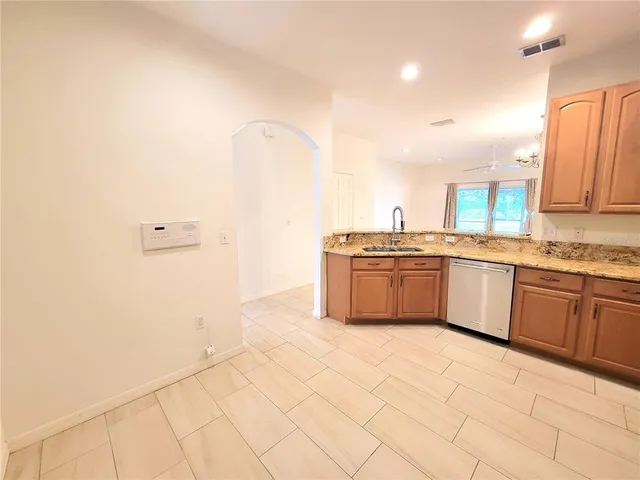 a large kitchen with a sink and white cabinets