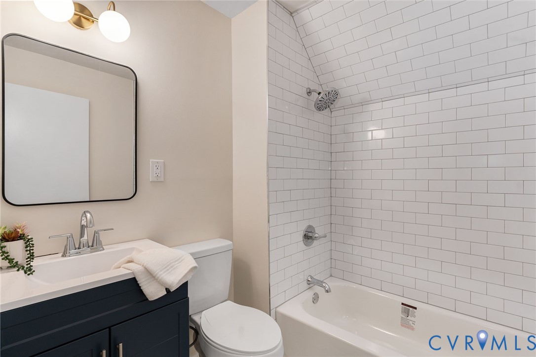 11345 Walton Lake Road Disputanta, VA 23842 - Photo 29 of 37 a bathroom with a sink vanity mirror and toilet