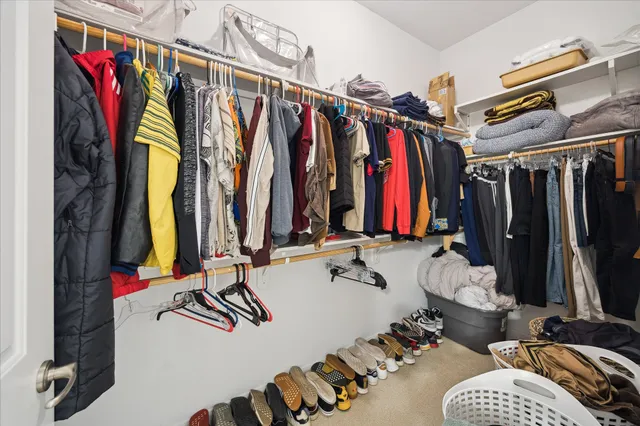 a view of walk in closet with clothes