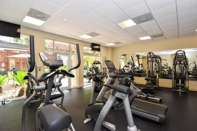 a living room with furniture and a large mirror