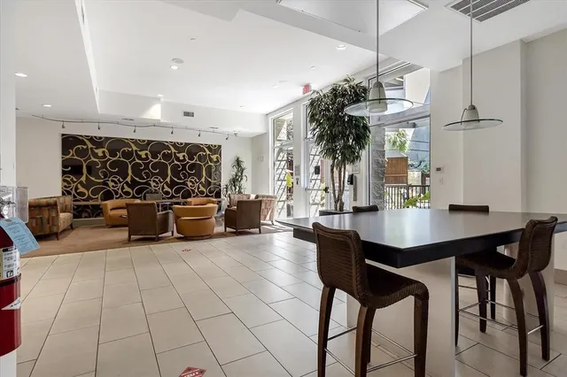 a room with furniture projector and screen