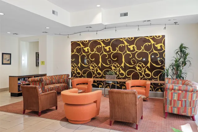 a living room with furniture a chandelier and a flat screen tv