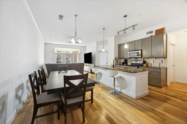 a view of kitchen with sink and refrigerator