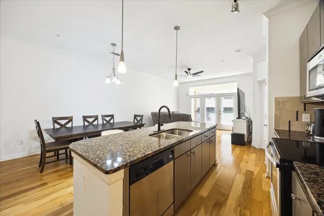 a kitchen with a stove a counter space and wooden floor