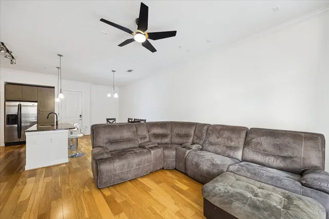 a living room with furniture and a wooden floor