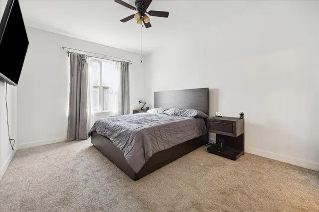 a bedroom with a bed and flat screen tv