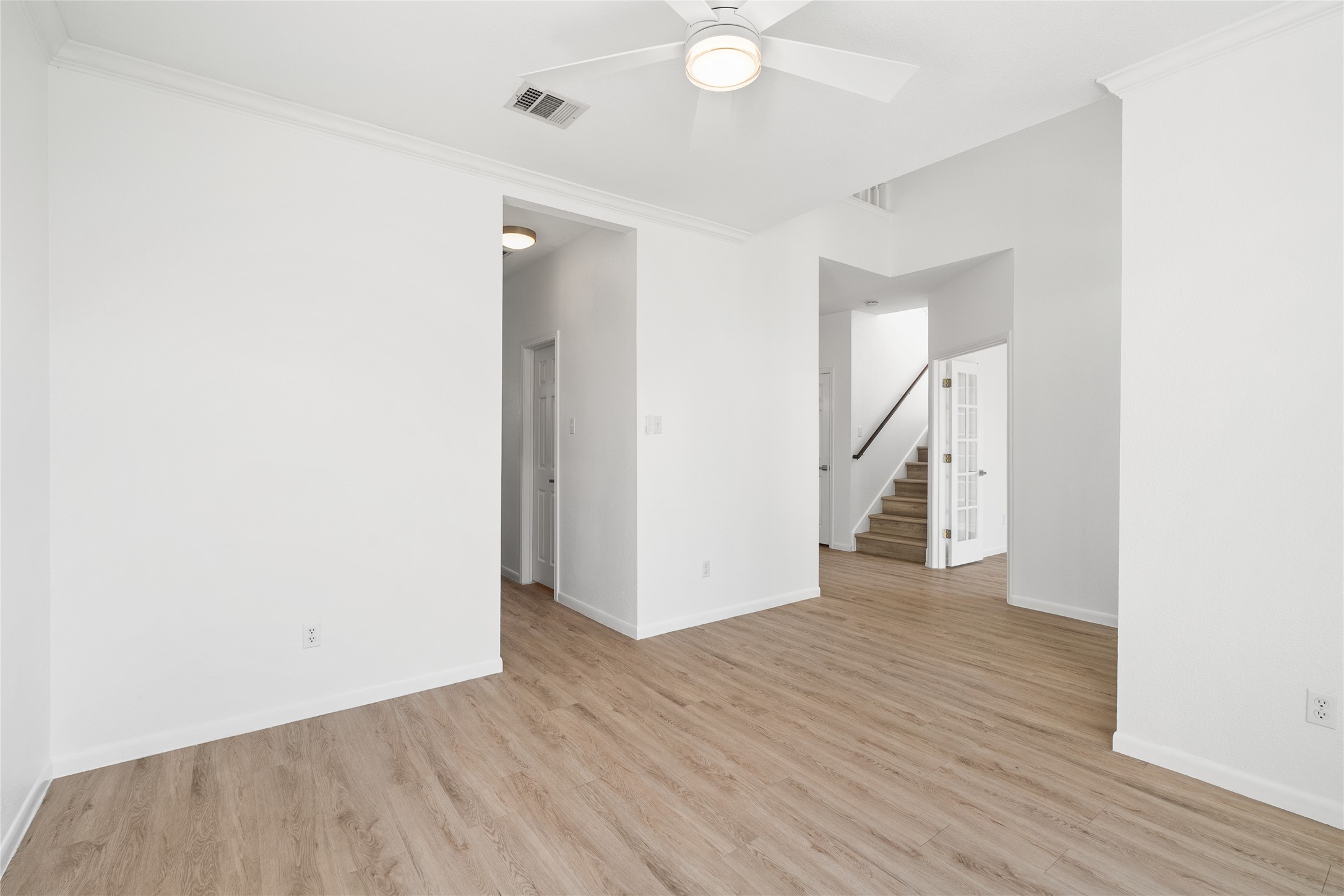 206 River Down Road Georgetown, TX 78628 - Photo 7 of 39 Open-concept living space with wood-finish flooring, white walls, and a ceiling fan