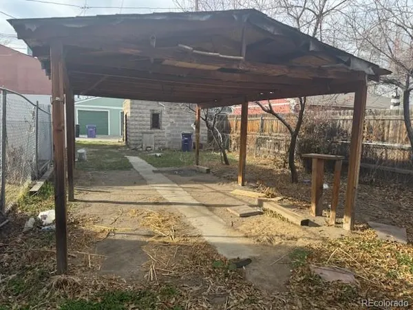 a backyard of a house with table and chairs
