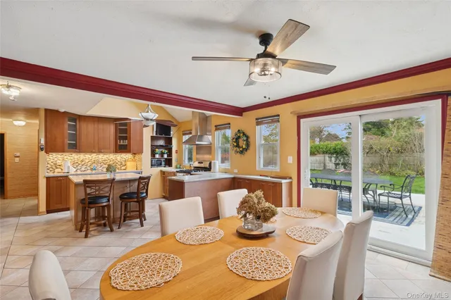 a dining room with furniture a large window and a rug
