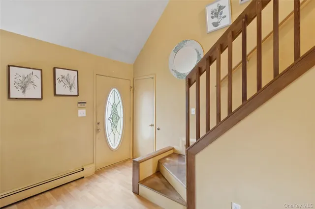 a view of staircase with railing and a window