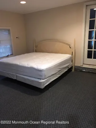 a large bed sitting in a bedroom next to a window