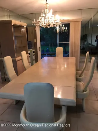a view of a dining room with furniture and chandelier