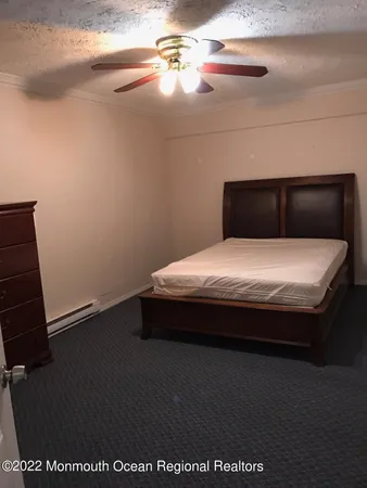 a large bed sitting in a bedroom next to a window