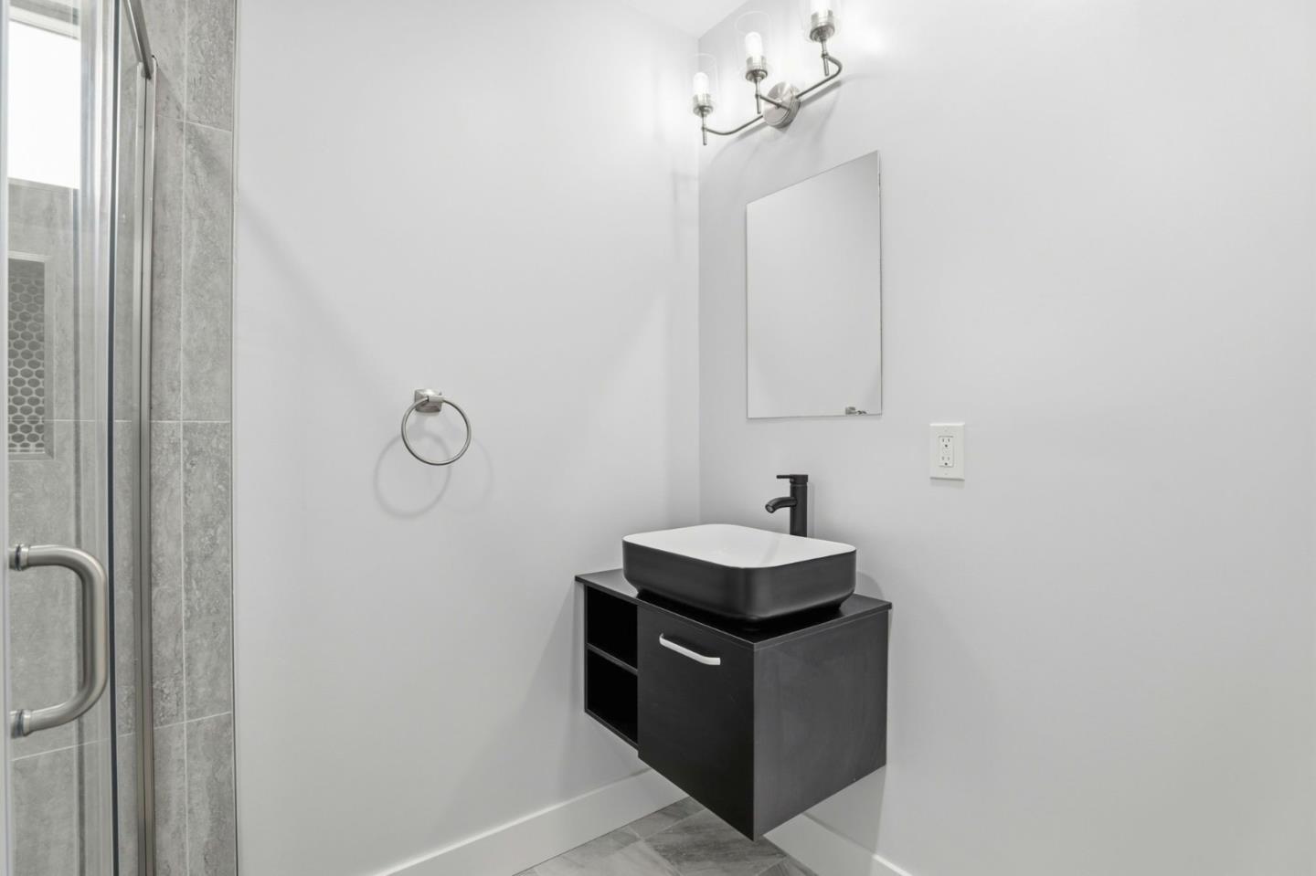 1802 Ponca Court Fremont, CA 94539 - Photo 22 of 28 a bathroom with a sink a light fixture and a shower