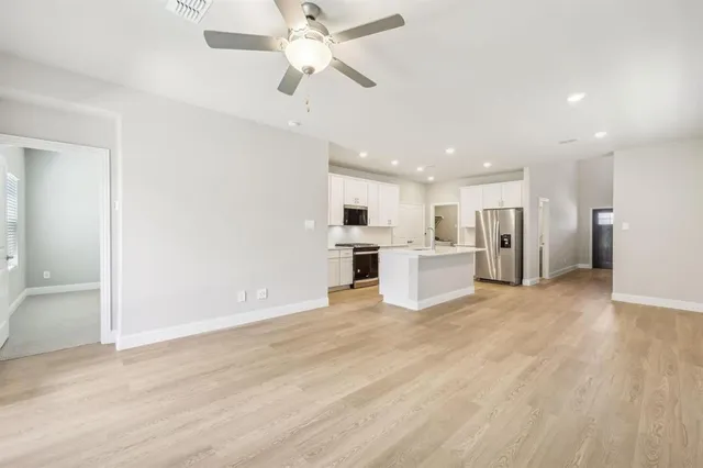 a view of a kitchen with a sink and a refrigerator